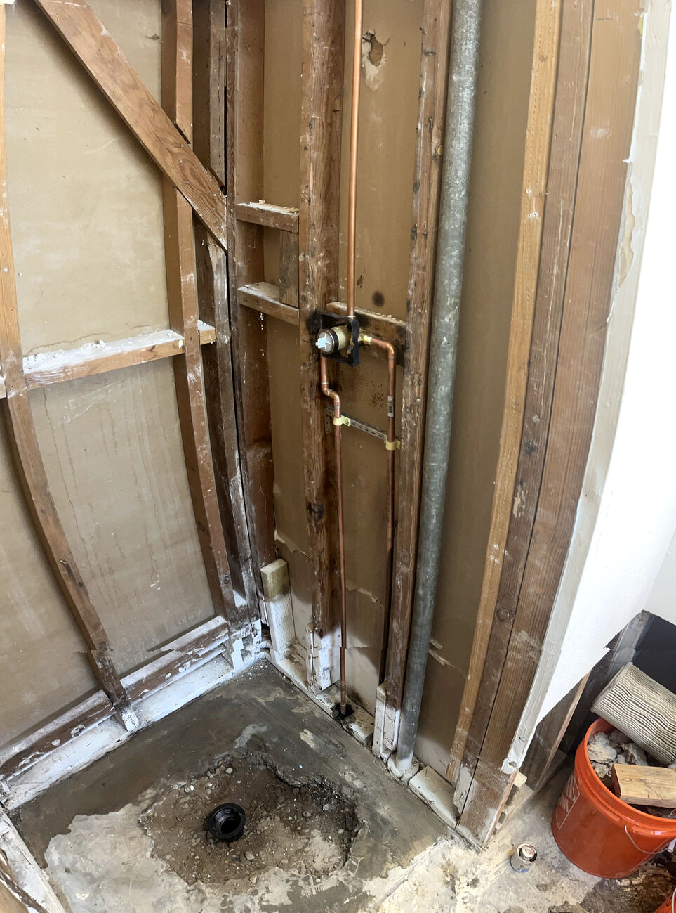 network of interconnected copper and PVC pipes within a residential plumbing system, illustrating the complexity of water supply and drainage infrastructure in a modern home.