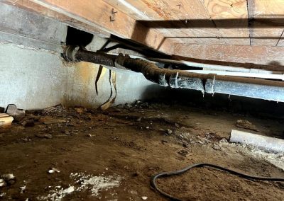 damaged sewer pipe section, showing cracks and deterioration, being replaced by a new pipe