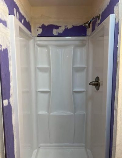 standard chrome shower valve used for controlling water flow and temperature in a residential bathroom shower