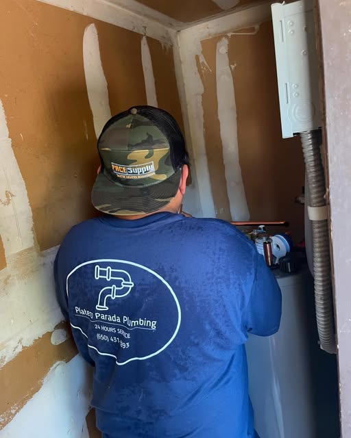 Experienced plumber conducting a complex sewer lateral replacement near a new   tankless water heater in Elk Grove.