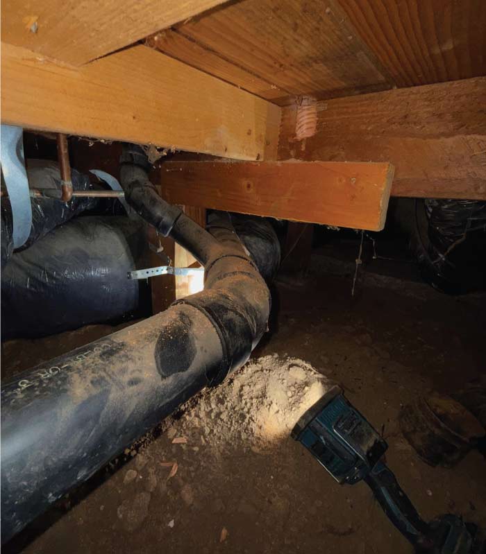 Experienced plumber conducting a complex sewer lateral replacement near a new   tankless water heater in Elk Grove.
