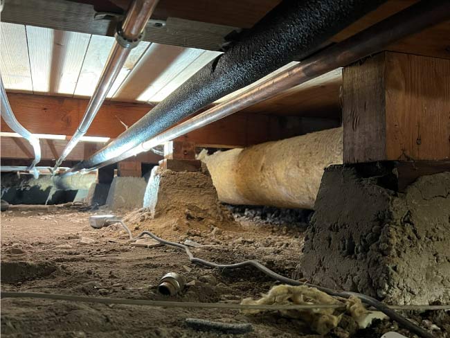 Technician securing a connection on an exterior main water line replacement.