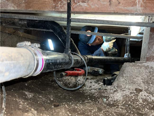 Licensed plumber installing new PEX piping for a whole-house repipe project.